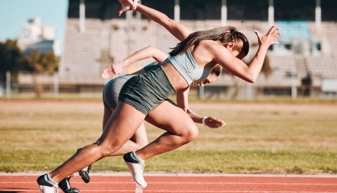Action, sports and athlete running sprint in competition or fitness game or training for energy wellness on track. Race, stadium and athletic people or runner exercise, speed and workout performance
