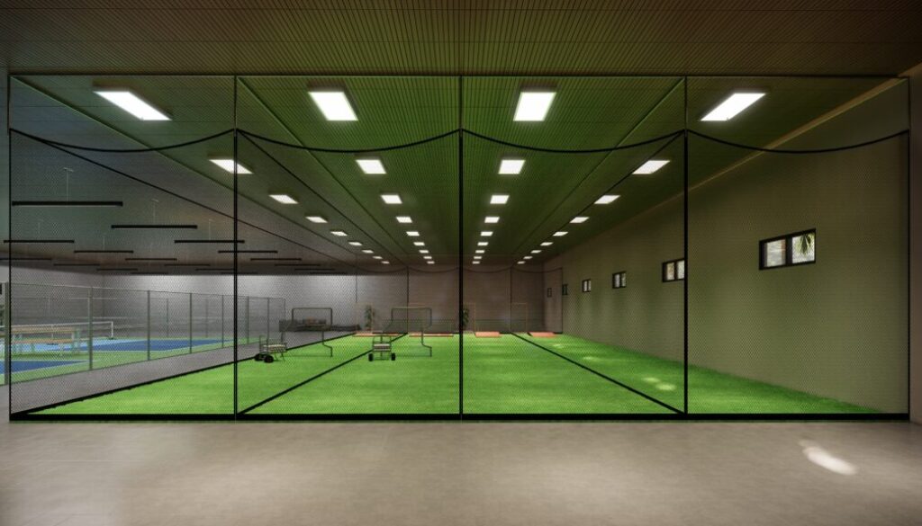Modern multi-sport indoor facility with turf fields and hard courts for baseball, softball, and tennis training.