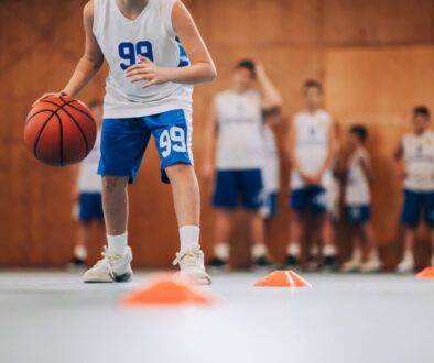 Youth basketball player practicing ball handling drills during a training session, which is a common starting point for basketball training businesses.